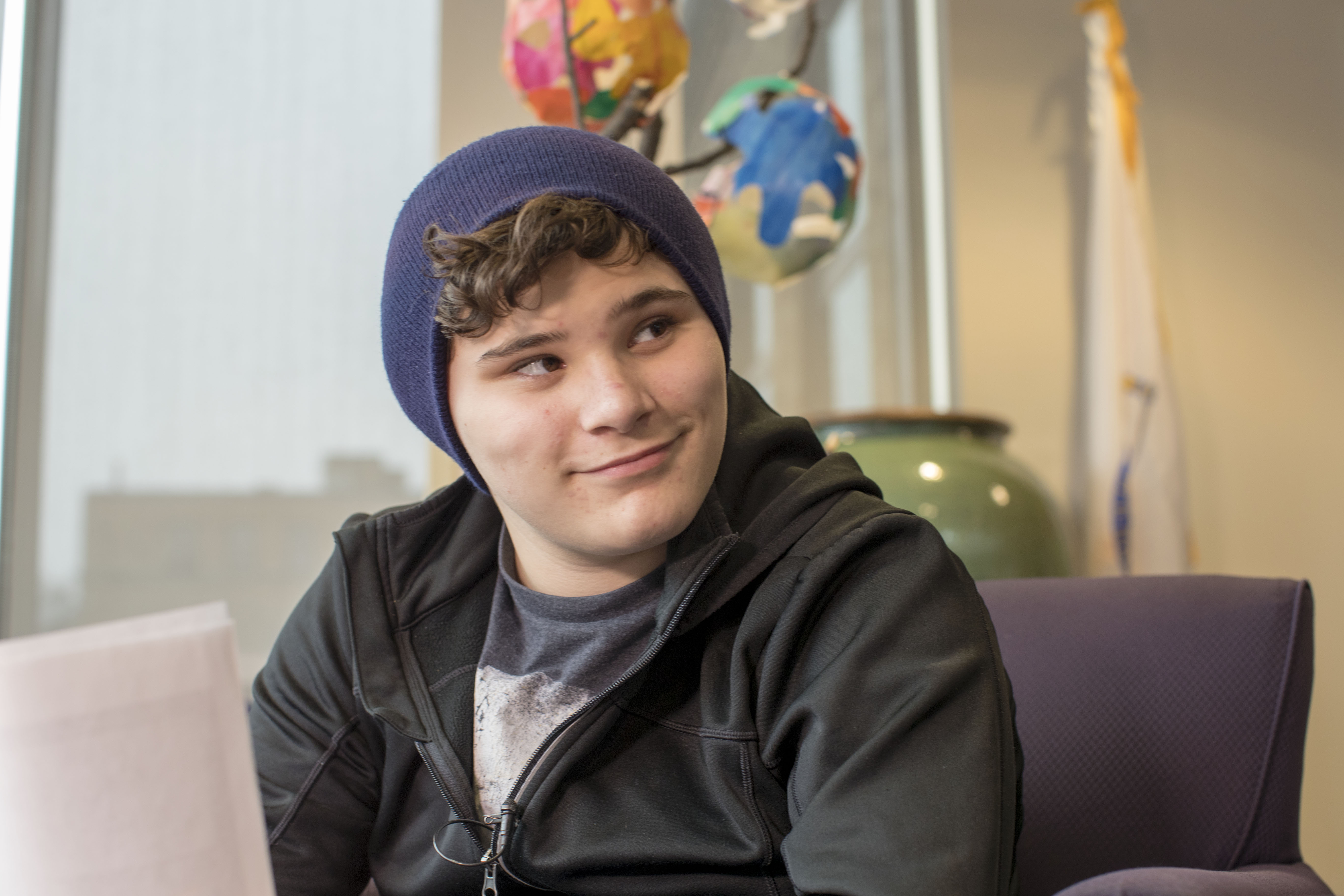 a young teen boy in a beanie