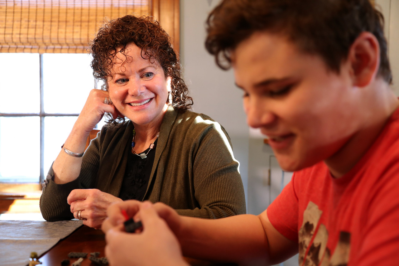 a happy mom looking at her teen son