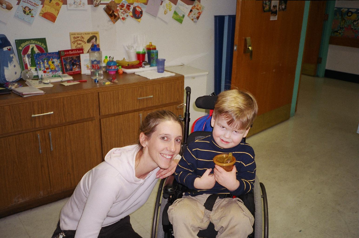 a woman and a boy in a wheelchair