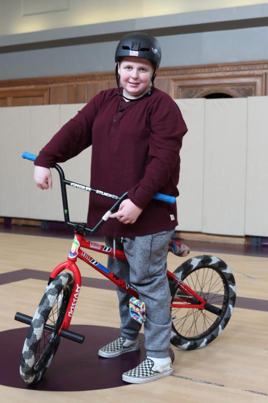 a teenage boy on a bike